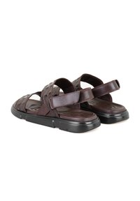 Bruine leren sandalen met meerdere kruisende banden, een gevoerd voetbed en een duurzame zwarte rubberen zool. Verstelbare klittenbanden.