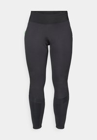 Fekete leggings magas derékkal, rugalmas anyagból készült. Zökkenőmentes textúrával rendelkezik, térdnél panelezett, és minimális márkaazonosító részlet található rajta.