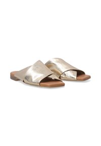 Gold metallic slide sandals with a cross-over design, flat brown sole, and smooth leather upper. Subtle texture and minimalist style.