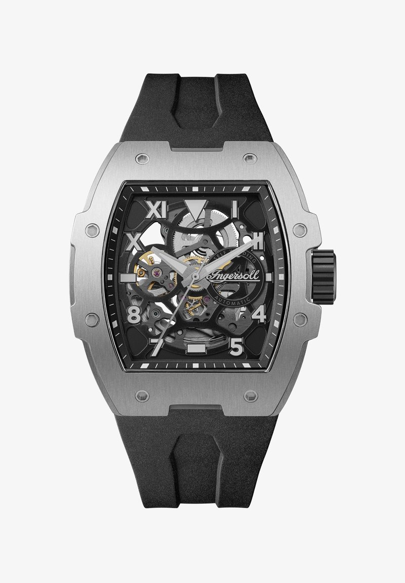 Automatische horloge met een roestvrijstalen kast, zwarte rubberen band, skeleton wijzerplaat, gedurfde witte uurmarkeringen en zichtbare bewegingscomponenten.