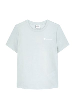 T-shirt en coton bleu clair à manches courtes, col rond, avec un petit logo blanc "Champion" sur la partie gauche de la poitrine.