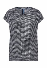 Top corto a maniche corte in bianco e nero con scollo rotondo. Presenta un motivo a pois testurizzato su un tessuto leggero.