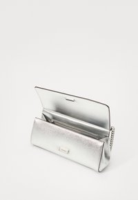 Metallic silver clutch bag, rectangular shape, textured finish, featuring a zipper pocket inside and a silver chain strap.
