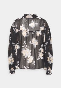 Black sheer blouse with a floral pattern in soft beige and light blue. Features a smocked neckline and long, gathered sleeves.