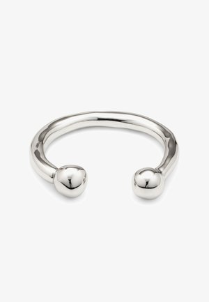 Brazalete de metal plateado con diseño liso y redondeado, que presenta dos extremos esféricos y un acabado pulido. Apariencia minimalista y elegante.