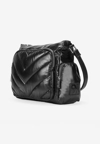 Bolso bandolera de nylon acolchado negro con un acabado brillante, que cuenta con un compartimento principal y múltiples bolsillos con cremallera. Correa ajustable.