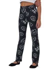 Pantaloni neri con grandi fantasie floreali e farfalle bianche, realizzati in tessuto elasticizzato con design svasato e vita alta.