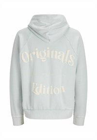 Light blue hoodie with a relaxed fit, featuring white block text "Originals Edition," ribbed cuffs, and a drawstring hood.