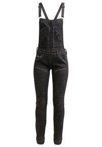 Black denim overalls with adjustable straps, front zip closure, multiple pockets, and fitted legs. Distressed detailing on the fabric.