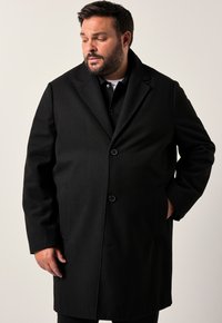 Cappotto in misto lana nero con colletto a scialle, due bottoni, tasche laterali e vestibilità sartoriale. Tessuto morbido e design classico.