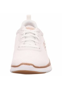 White mesh athletic shoe with white laces, beige sole trim, and a pull tab at the heel, viewed from the front.