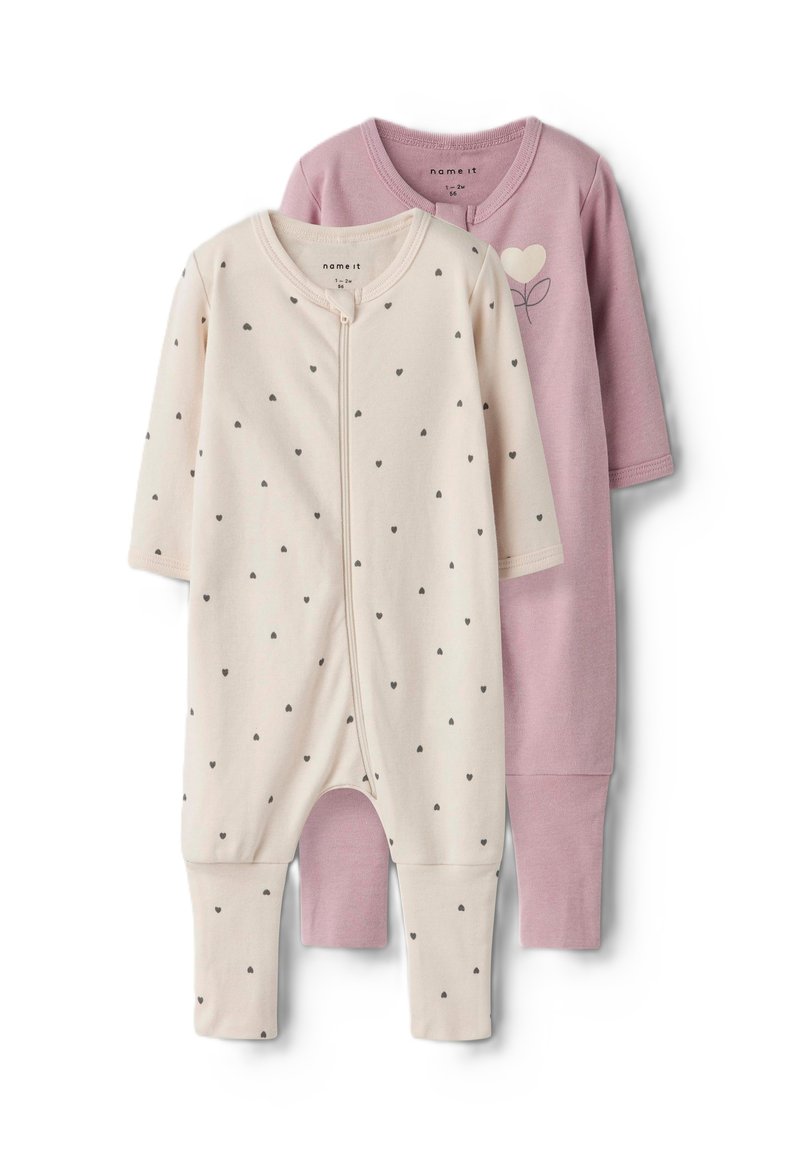 Deux bodys en taille bébé : l'un crème avec des cœurs gris et une fermeture éclair à l'avant, l'autre rose avec un design simple de cœur et de feuille. En matériau coton doux.