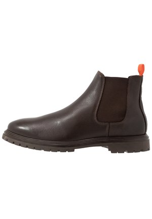 Dark brown leather Chelsea boot with a rugged sole, elastic side panels, and an orange pull tab at the back.
