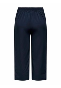 Pantalon de sport léger bleu marine avec une taille élastique et une coupe ample, présentant une texture lisse et une longueur aux genoux.