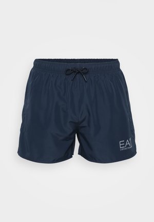 Námořnické modré plavky vyrobené z lehkého materiálu. Mají elastický pas s šňůrkou a malé logo na přední straně.