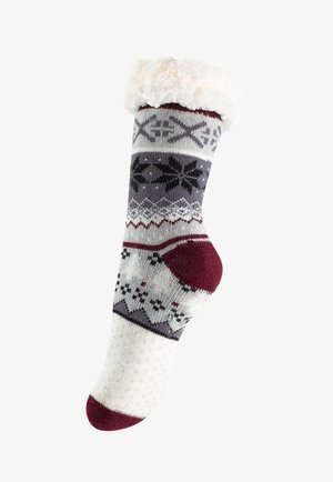 Calzino lavorato a maglia in crema, grigio e bordeaux con motivi di fiocchi di neve e geometrici; polsino bianco morbido e dettagli in rilievo antiscivolo sulla suola.