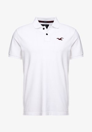 Weißes Polohemd aus elastischer Baumwolle. Verfügt über einen klassischen Kragen, zwei schwarze Knöpfe und ein kastanienbraunes Vogel-Logo auf der Brust.