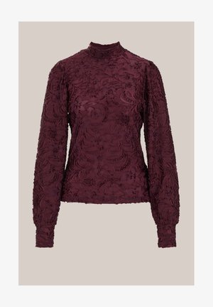Bordeauxrode top met lange mouwen en een hoge halslijn, voorzien van ingewikkeld bloemenborduursel en een gestructureerde stof. Getailleerde pasvorm, elastische boorden.
