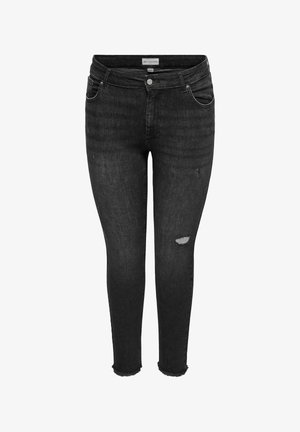 Mustad kitsad teksapüksid tuhmunud pesuga, rebitud detailidega reitel, narmendatud ääred, eesmine nööbi- ja tõmblukuga kinnis ning viie taskuga disain.