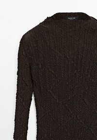 Black textured long-sleeve top with a wrinkled pattern. Features a round neckline and soft, stretchable material for comfort.
