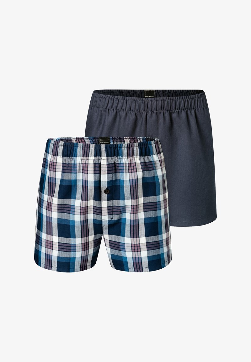 Two pairs of men's boxers. One is plaid in navy, white, and purple; the other is solid dark gray. Elastic waistband on both.