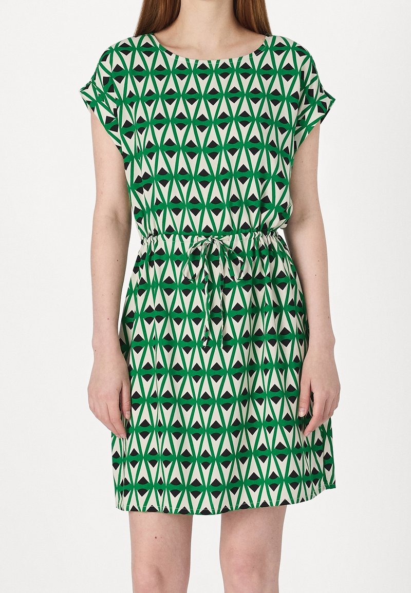 Green and off-white dress featuring a geometric triangle pattern, short sleeves, and an adjustable drawstring waist. Lightweight fabric.