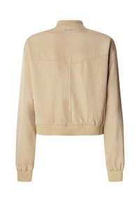 Cropped beige jacket with ribbed hem and cuffs, featuring a simple design and a back yoke detail. Material appears smooth and lightweight.