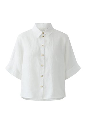 Wit overhemd met korte mouwen, een klassieke kraag en zeven kleine beige knopen aan de voorkant.