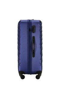 Hard-shell suitcase in a glossy dark blue finish, featuring a textured zigzag pattern, dual wheels, and a retractable handle.
