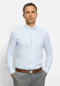 Light blue button-up shirt with a textured pattern, long sleeves, and a collar, paired with gray trousers and a brown belt.