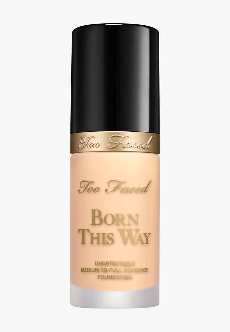 Too Faced Born This Way Foundation in einer mattierten Glasflasche mit schwarzem Deckel. Verziert mit goldenen Schriftzügen und einer weichen beige Produktfarbe.