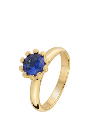 Gold ring with a round deep blue sapphire stone held by eight prongs against a white background.