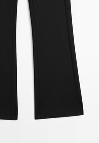 Black flared trousers made of smooth fabric, featuring a clean design with stitched seams, without any visible hardware or patterns.