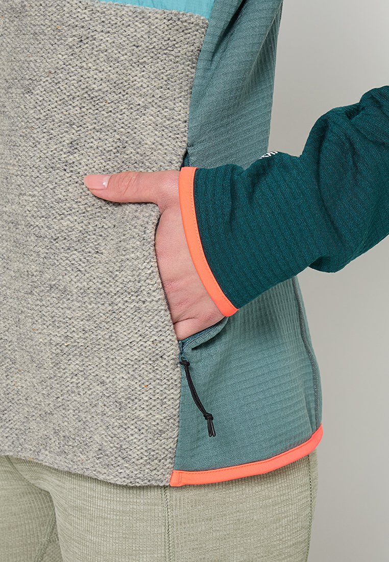 Fleecejacke mit einer strukturierten grauen Vorderseite, tealfarbener Oberseite und grünem Ärmel mit orangefarbigen Akzenten. Mit Reißverschlusstasche und Kordelzugdetail.