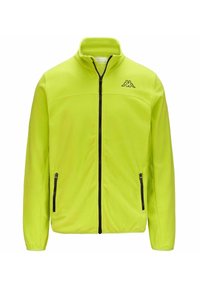 Giacca in pile neon gialla brillante con colletto alto, zip frontale e due tasche laterali con zip. Presenta un logo nero sul petto.