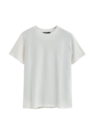 Hellbeige T-Shirt mit kurzen Ärmeln, aus weicher Baumwolle gefertigt. Mit Rundhalsausschnitt und einem kleinen Logopatch in der linken unteren Ecke.