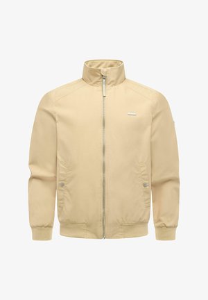 Veste beige à fermeture éclair avec col montant, poignets et ourlet élastiques, deux poches avant à boutons-pression, et un petit logo rectangulaire sur la poitrine.