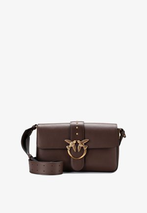 Brown leather handbag with a magnetic flap, gold-tone swallow motif, and studs. Features an adjustable strap and a circular hardware accent.