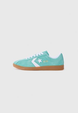 Mint green suede sneaker with white accents, rubber sole, star logo, and "ALL STAR" branding in gold on the side. Lightweight design.
