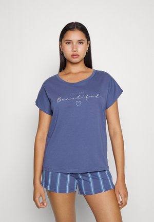 Purple cotton t-shirt with short sleeves featuring a "You Are Beautiful" print, paired with blue and white striped shorts.
