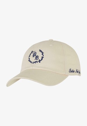 Cremfarbener Baseballcap mit navyblauer bestickter Logo, mit einem gebogenen Schirm und dekorativem Text an der Seite. Baumwollstoff, strukturierte Form.