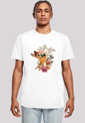 White cotton t-shirt featuring a colorful illustration of a deer amidst various flowers. The design includes greens, pinks, and yellows.