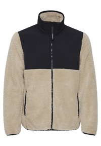 Beige fuzzy fleece jacket with a black quilted upper section, high collar, full front zipper, and side pockets. Textured fabric details visible.