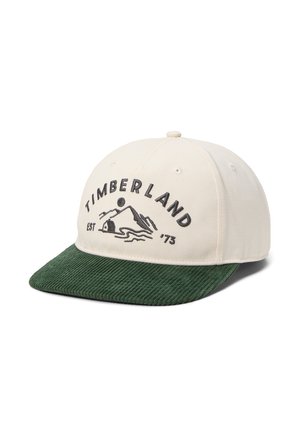 Gorra Timberland blanca y verde con visera de pana y logo de montaña con "Timberland Est '73" bordado en el frente.