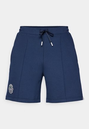 Shorts de sport bleu marine en tissu texturé, avec une taille élastique et un cordon de serrage, et un logo cousu sur la jambe gauche.