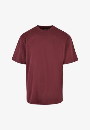 Burgundowa koszulka z krótkim rękawem z bawełny. Posiada okrągły dekolt, luźny krój i gładką fakturę. Bez wzorów ani ozdób.