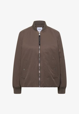 Hnědá bomber bunda se zapínáním na přední zip, žebrovaným límcem a manžetami, dvěma kapsami na cvočky a látkovou štítkem na tahu zipu.