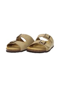 Beige suede sandals with two adjustable straps, cork footbed, open-toe design, and textured rubber outsole for grip.