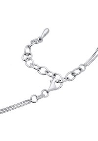 Sølvarmbånd med sammenlåsende kædelinks, et struktureret design og en sikker langsom lukning, mærket med "925" for sterling sølv.