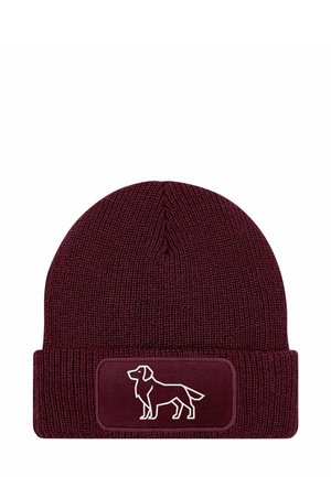 Burgundy knit beanie with a folded cuff, featuring a textured finish and a stitched white dog silhouette on a rectangular patch.